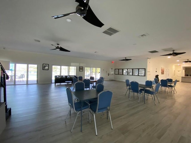 dining space featuring visible vents, wood finished floors, and a ceiling fan