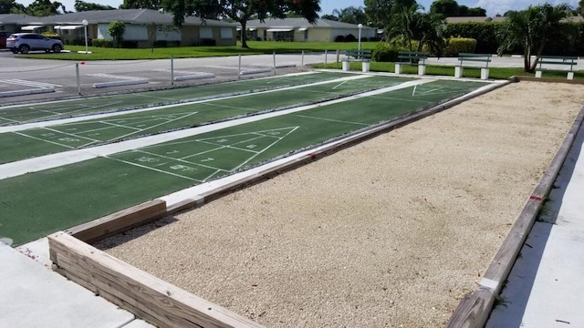 view of home's community featuring shuffleboard and a lawn