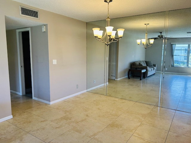 unfurnished dining area featuring light tile patterned floors, baseboards, visible vents, and a textured ceiling