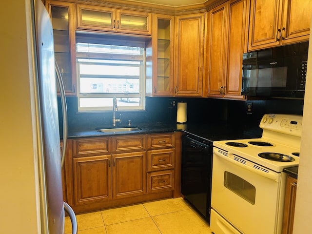 kitchen featuring a sink, black appliances, brown cabinetry, and light tile patterned floors