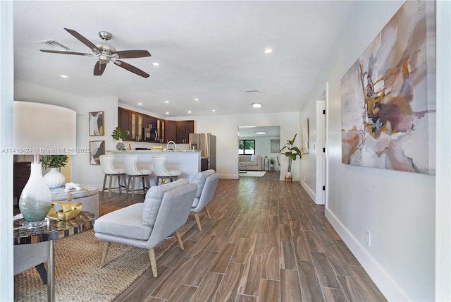 living area featuring dark wood finished floors, visible vents, recessed lighting, and baseboards