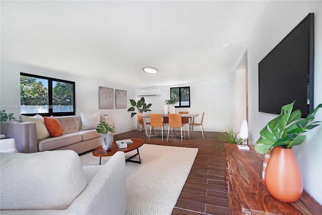 living area featuring baseboards, dark wood-type flooring, and a wall mounted AC