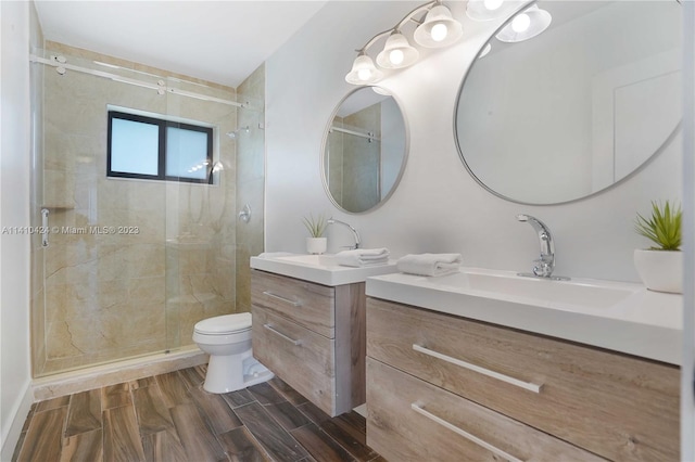 full bath with wood finish floors, vanity, toilet, and a shower stall