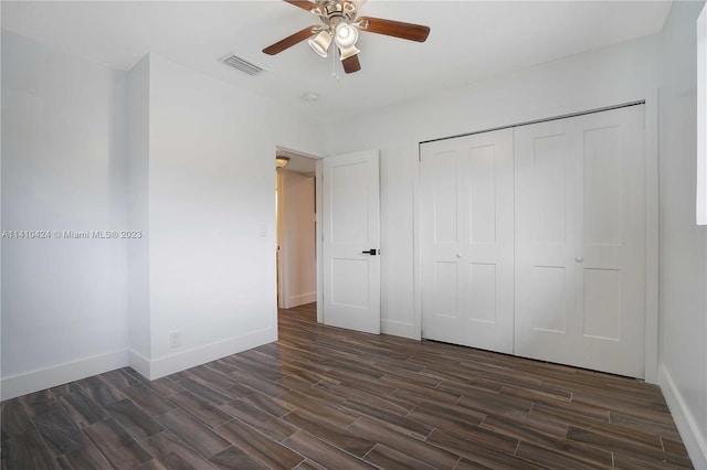 unfurnished bedroom featuring a ceiling fan, baseboards, visible vents, wood finish floors, and a closet