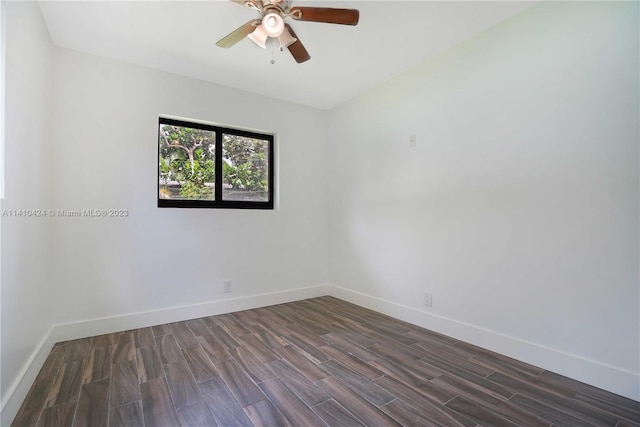 unfurnished room featuring ceiling fan, dark wood-type flooring, and baseboards