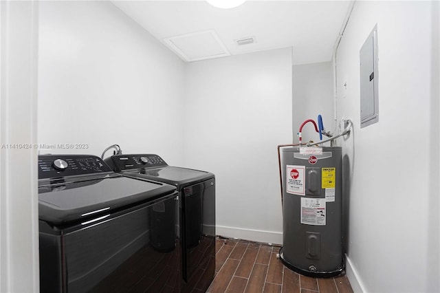 clothes washing area with wood tiled floor, electric panel, water heater, laundry area, and washing machine and clothes dryer