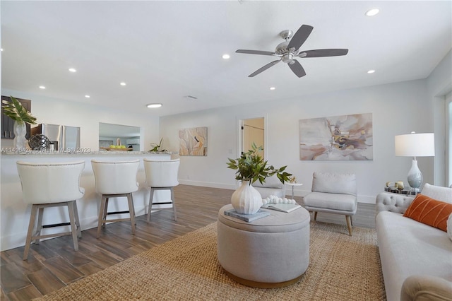 living area with recessed lighting, baseboards, and wood finished floors