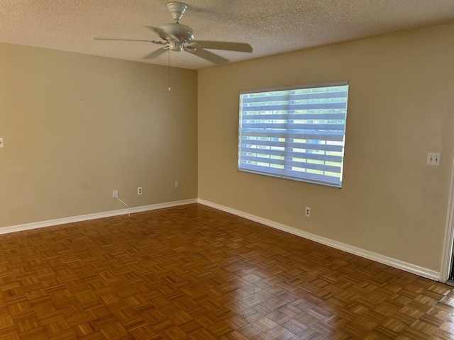 empty room featuring ceiling fan, baseboards, and a textured ceiling