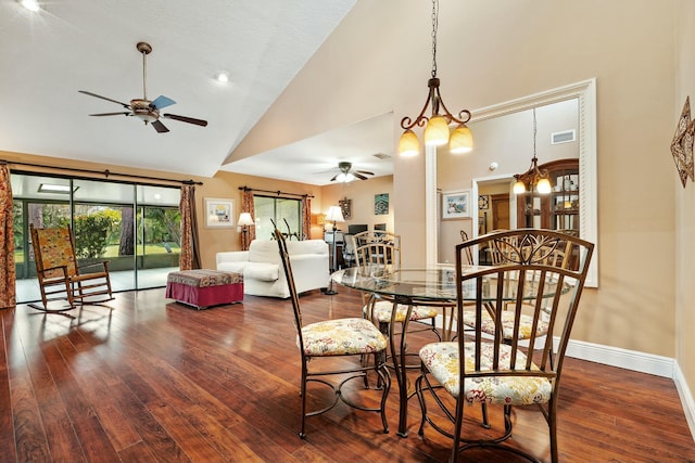 dining area featuring visible vents, high vaulted ceiling, ceiling fan with notable chandelier, wood finished floors, and baseboards