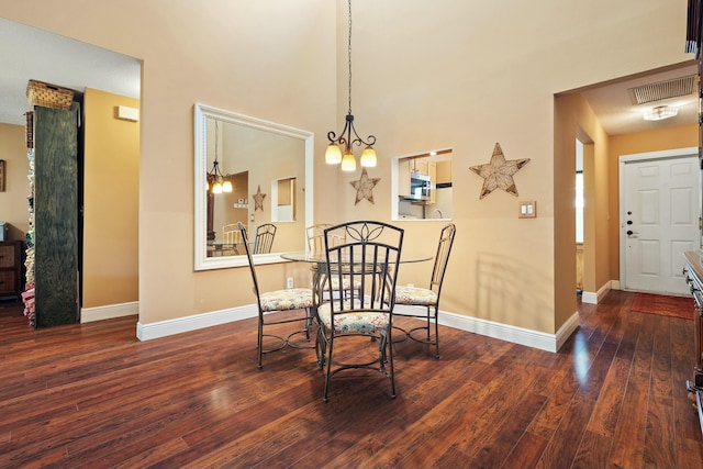 dining area with hardwood / wood-style floors, baseboards, visible vents, and a chandelier