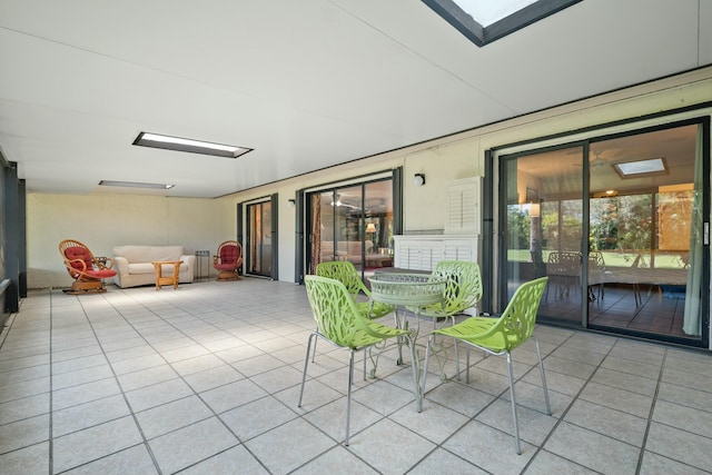 unfurnished sunroom featuring a skylight