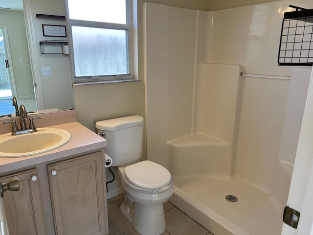 bathroom featuring tile patterned flooring, a healthy amount of sunlight, a stall shower, and toilet