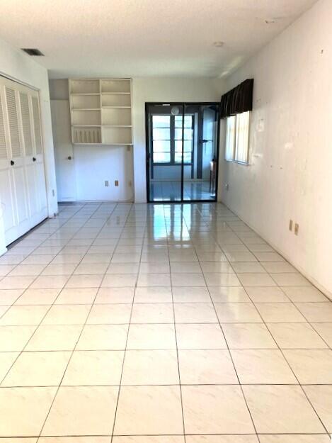 unfurnished room featuring light tile patterned floors and visible vents