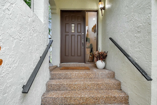 entrance to property featuring stucco siding