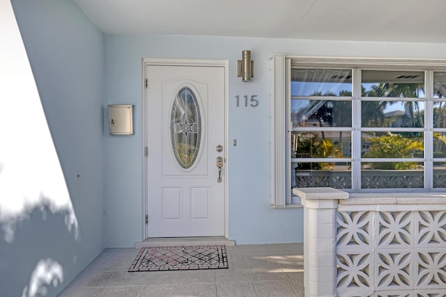 115 Elwa Pl, West Palm Beach, FL 33405 - doorway to property featuring stucco siding