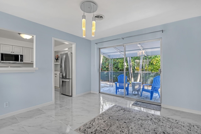 115 Elwa Pl, West Palm Beach, FL 33405 - kitchen featuring stainless steel appliances, light marble finish flooring, baseboards, decorative light fixtures, and white cabinetry