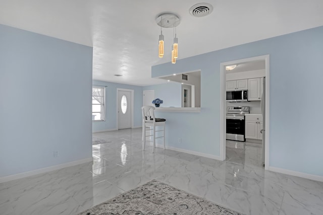 115 Elwa Pl, West Palm Beach, FL 33405 - kitchen featuring stainless steel appliances, light marble finish flooring, baseboards, and light countertops