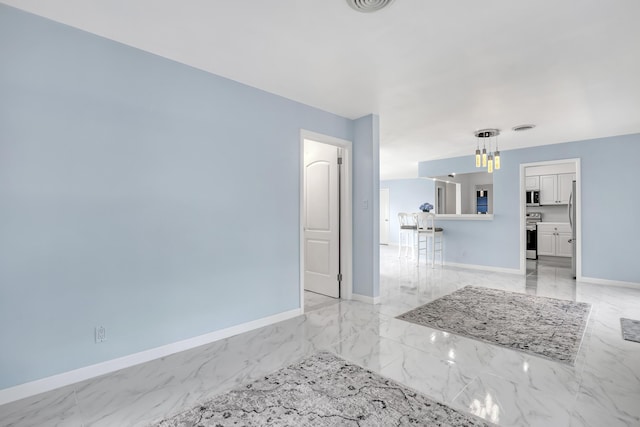 115 Elwa Pl, West Palm Beach, FL 33405 - empty room with baseboards, light marble finish flooring, and a chandelier