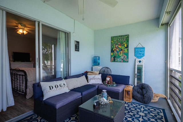 living area featuring wood finished floors and ceiling fan