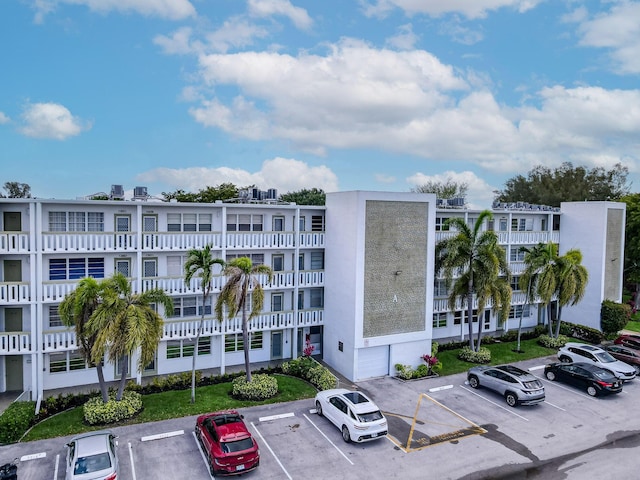 view of building exterior featuring uncovered parking