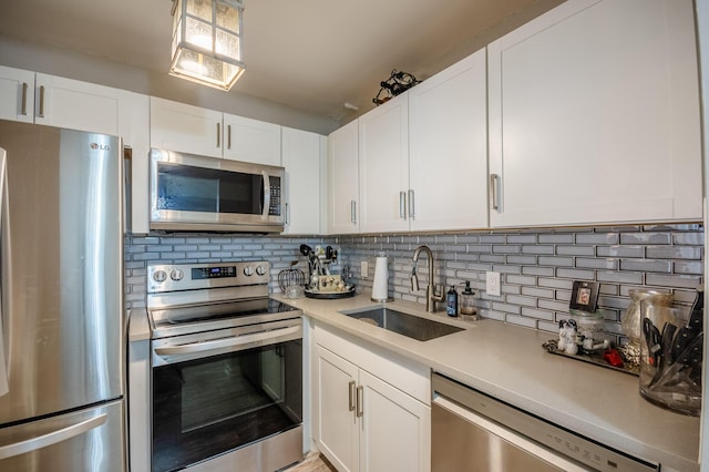 2012 Durham A, Deerfield Beach, FL 33442 - kitchen featuring stainless steel appliances, a sink, light countertops, and decorative backsplash