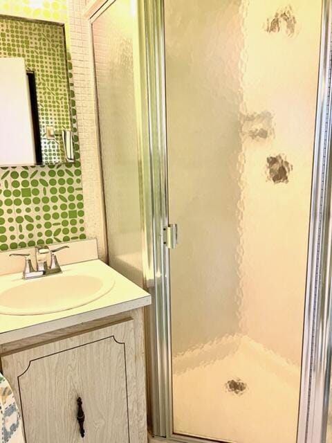 bathroom featuring vanity and a shower stall