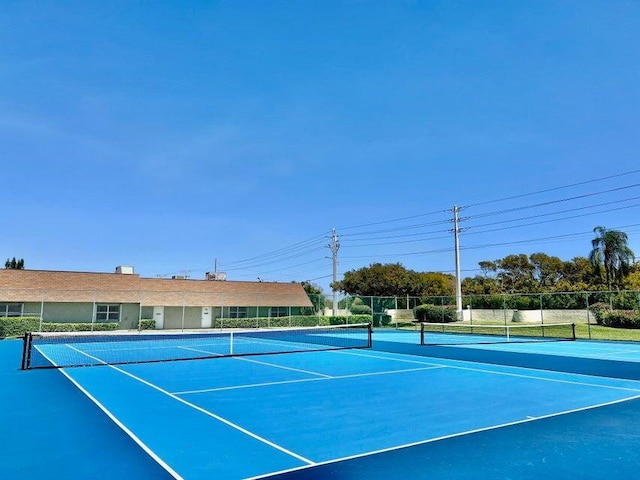 view of sport court featuring fence