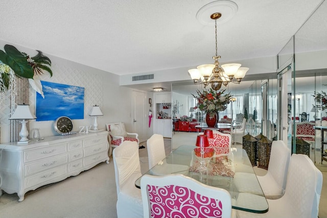 dining room with visible vents, wallpapered walls, a chandelier, light carpet, and a textured ceiling