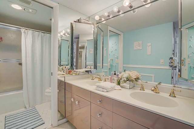 full bathroom with double vanity, toilet, shower / bath combo with shower curtain, and a sink