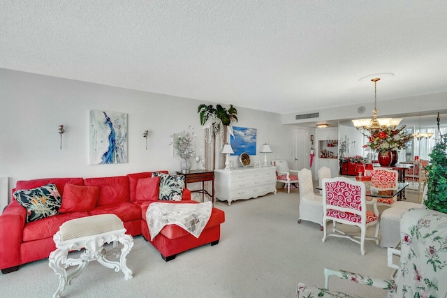 living area featuring a notable chandelier, a textured ceiling, visible vents, and carpet floors