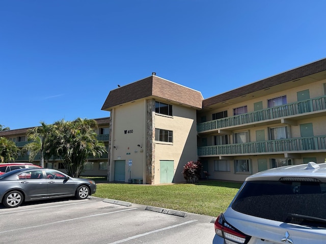 view of building exterior featuring uncovered parking