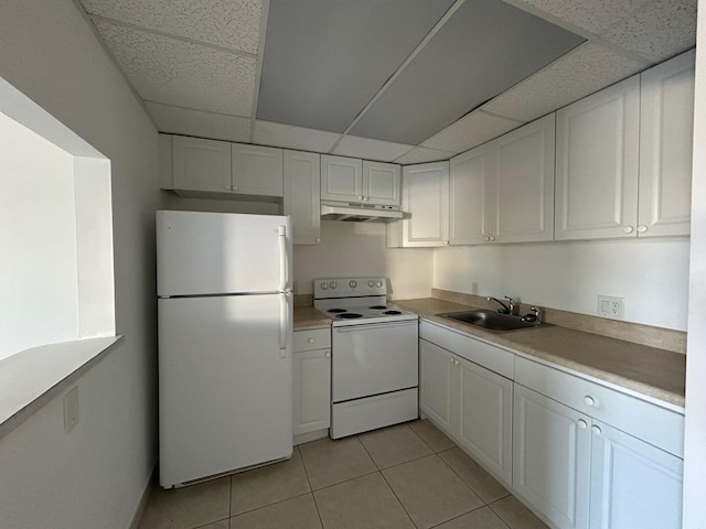 kitchen featuring under cabinet range hood, white appliances, white cabinetry, and a sink