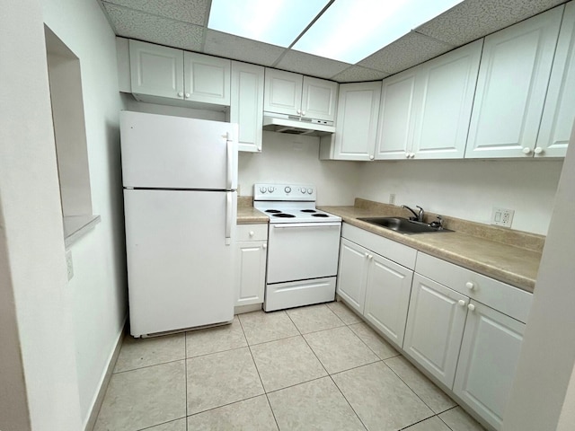 kitchen featuring white appliances, white cabinets, under cabinet range hood, and a sink