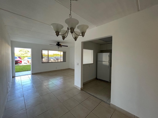 unfurnished room featuring baseboards, light tile patterned flooring, and ceiling fan with notable chandelier