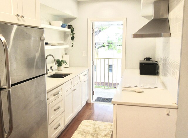 11 SW 4th Ave Unit 8, Boca Raton, FL 33432 - kitchen with freestanding refrigerator, wall chimney range hood, a sink, open shelves, and dark wood-style flooring
