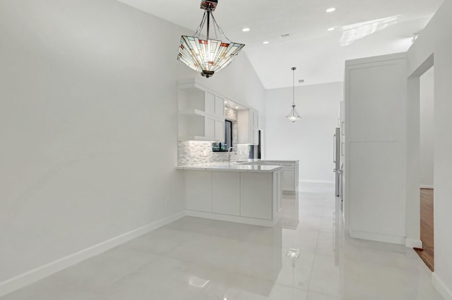 kitchen featuring open shelves, a peninsula, white cabinets, light countertops, and decorative backsplash