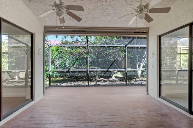 unfurnished sunroom with plenty of natural light and ceiling fan