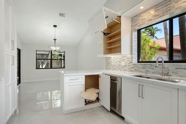 kitchen featuring visible vents, a sink, light countertops, a peninsula, and open shelves