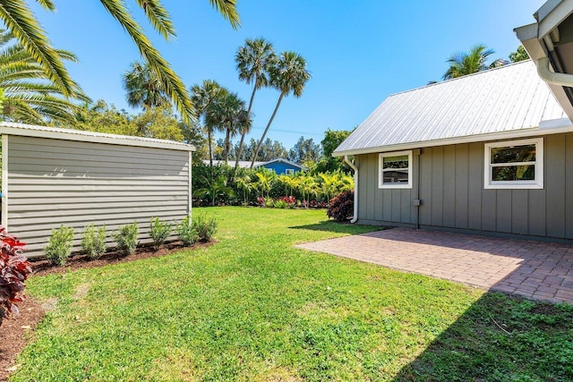 view of yard with an outdoor structure and a patio