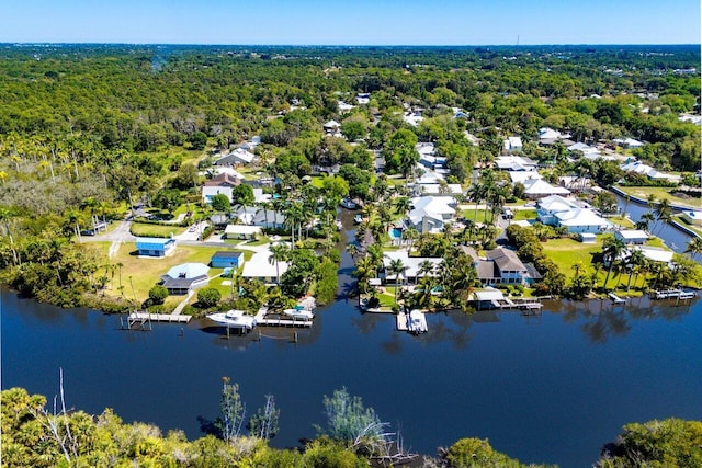 birds eye view of property featuring a forest view, a residential view, and a water view