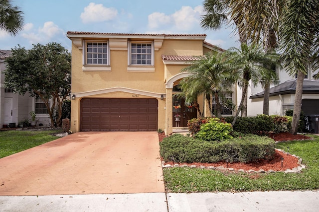 mediterranean / spanish home featuring stucco siding, concrete driveway, an attached garage, and a tile roof