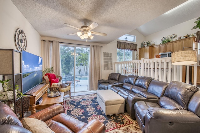 living area featuring a textured ceiling, lofted ceiling, and ceiling fan