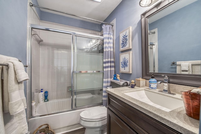 bathroom with vanity, toilet, and enclosed tub / shower combo