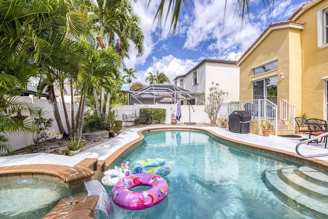 view of swimming pool featuring a patio, a fenced backyard, a fenced in pool, and grilling area