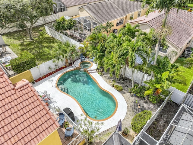 view of pool with a patio, a fenced backyard, and a pool with connected hot tub