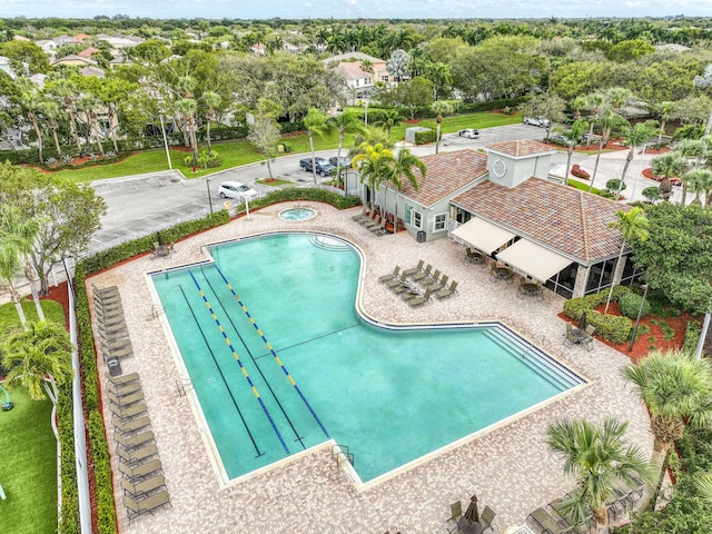 community pool with a patio and a community hot tub