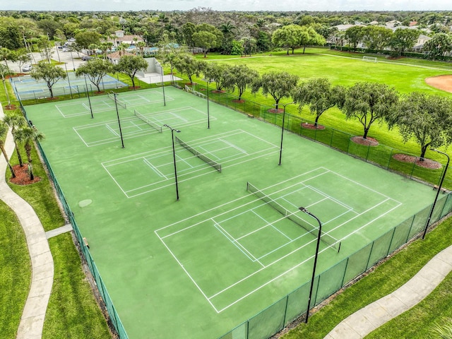 view of sport court featuring fence