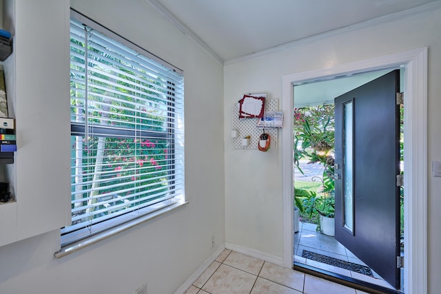 entrance foyer with light tile patterned flooring, crown molding, and baseboards