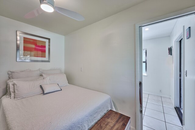 bedroom featuring light tile patterned flooring and a ceiling fan