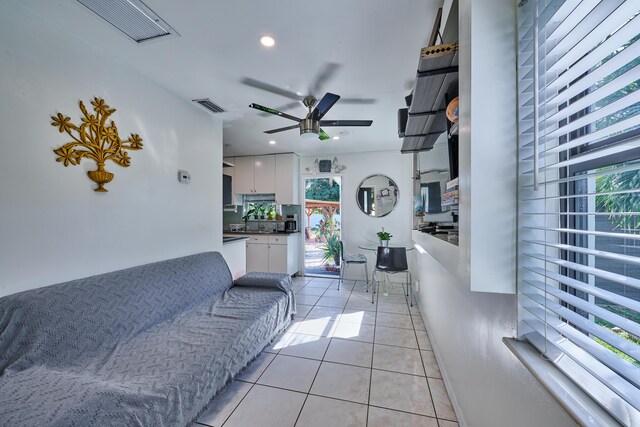 living area with light tile patterned floors, visible vents, ceiling fan, and recessed lighting